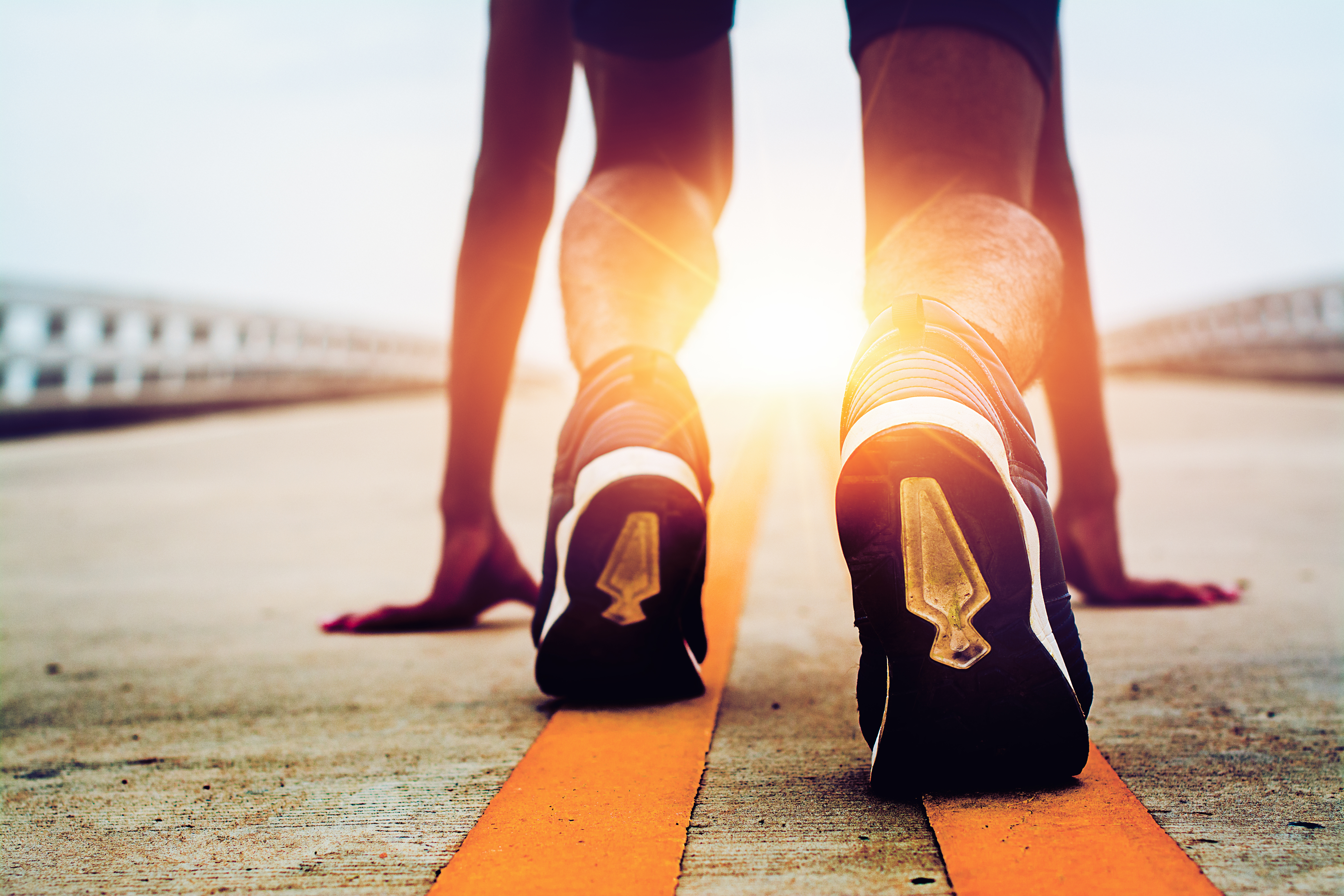 athletes are starting on the road with morning sunshine